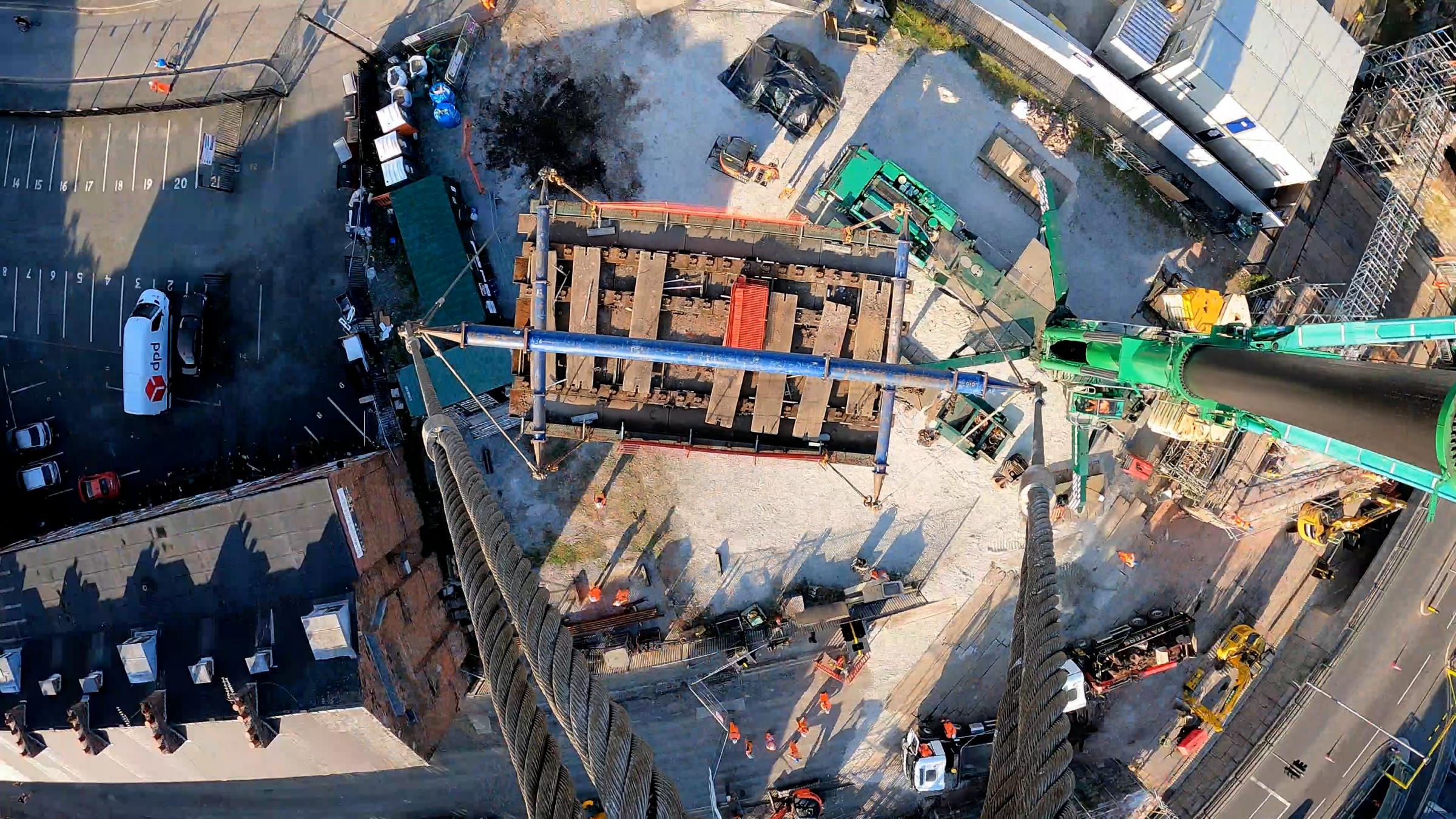 A crane-eye view of the old bridge being lifted out of place