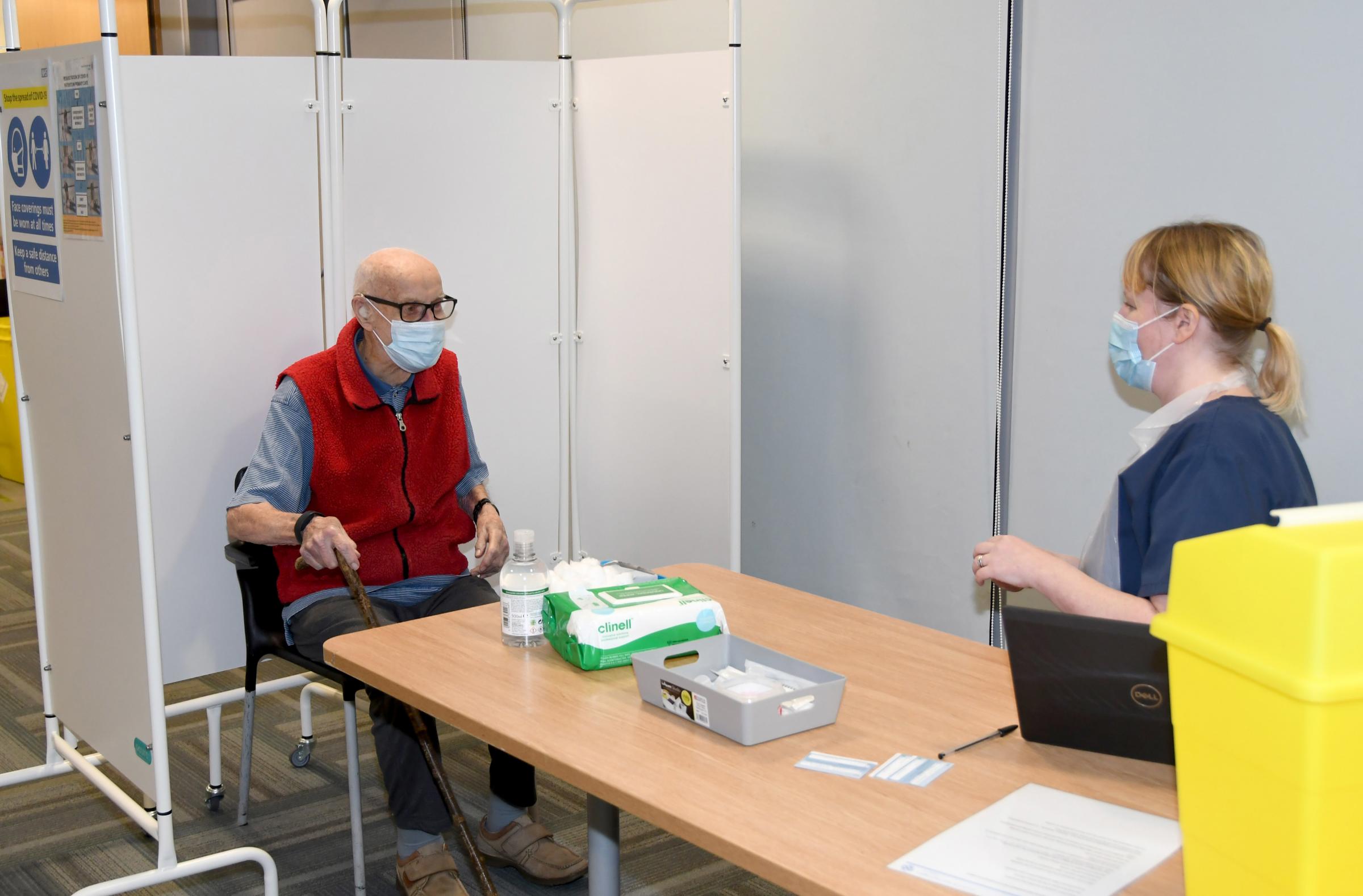 Dr Phillip Leech prepares to receive Warringtons first Covid vaccination from Dr Laura Mount