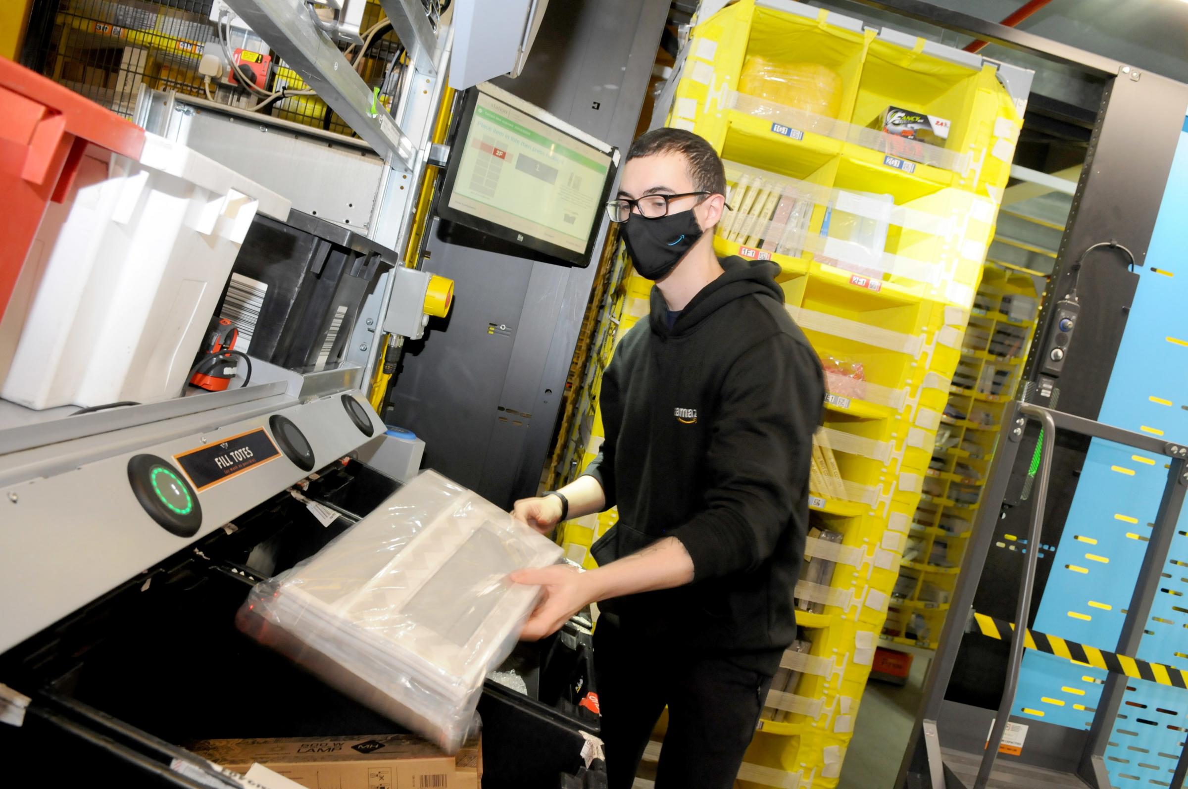 Rodrigo Tomaz picks the products ready for them to be packed