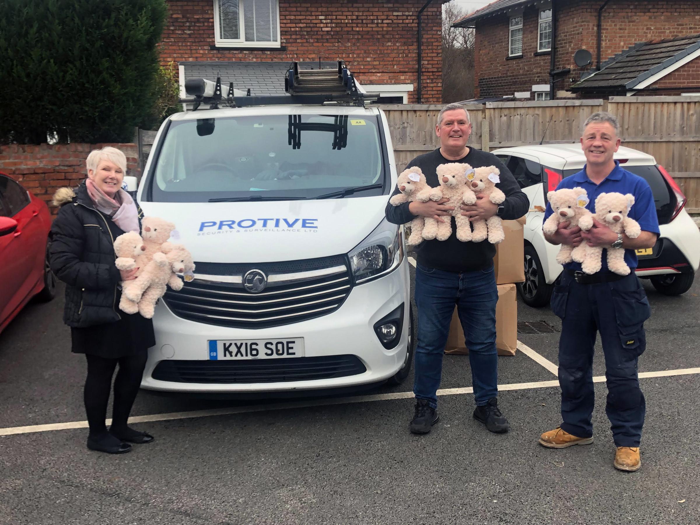 Helen Higginson receives a special delivery from Shaun Ryan and Paul Fowler of Protive Security