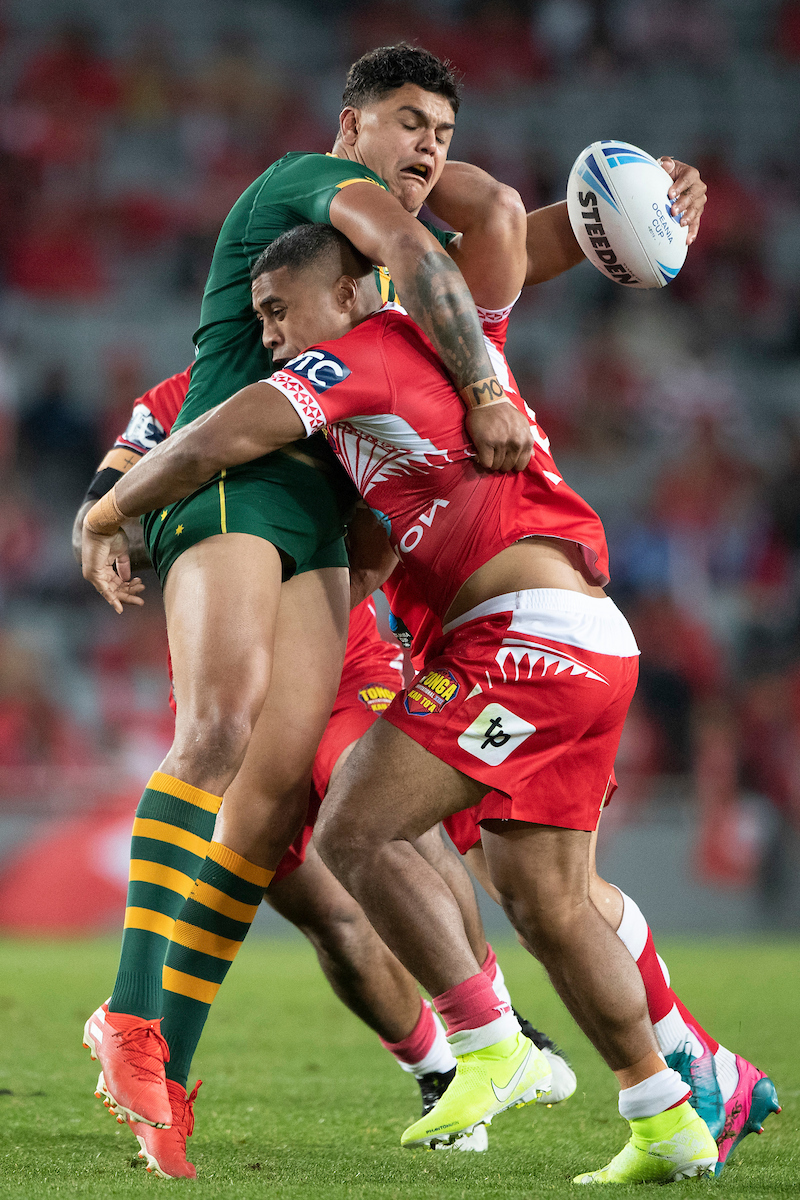 Cook Islands' Kayal Iro (centre) tackled by Tonga's Will Penisini