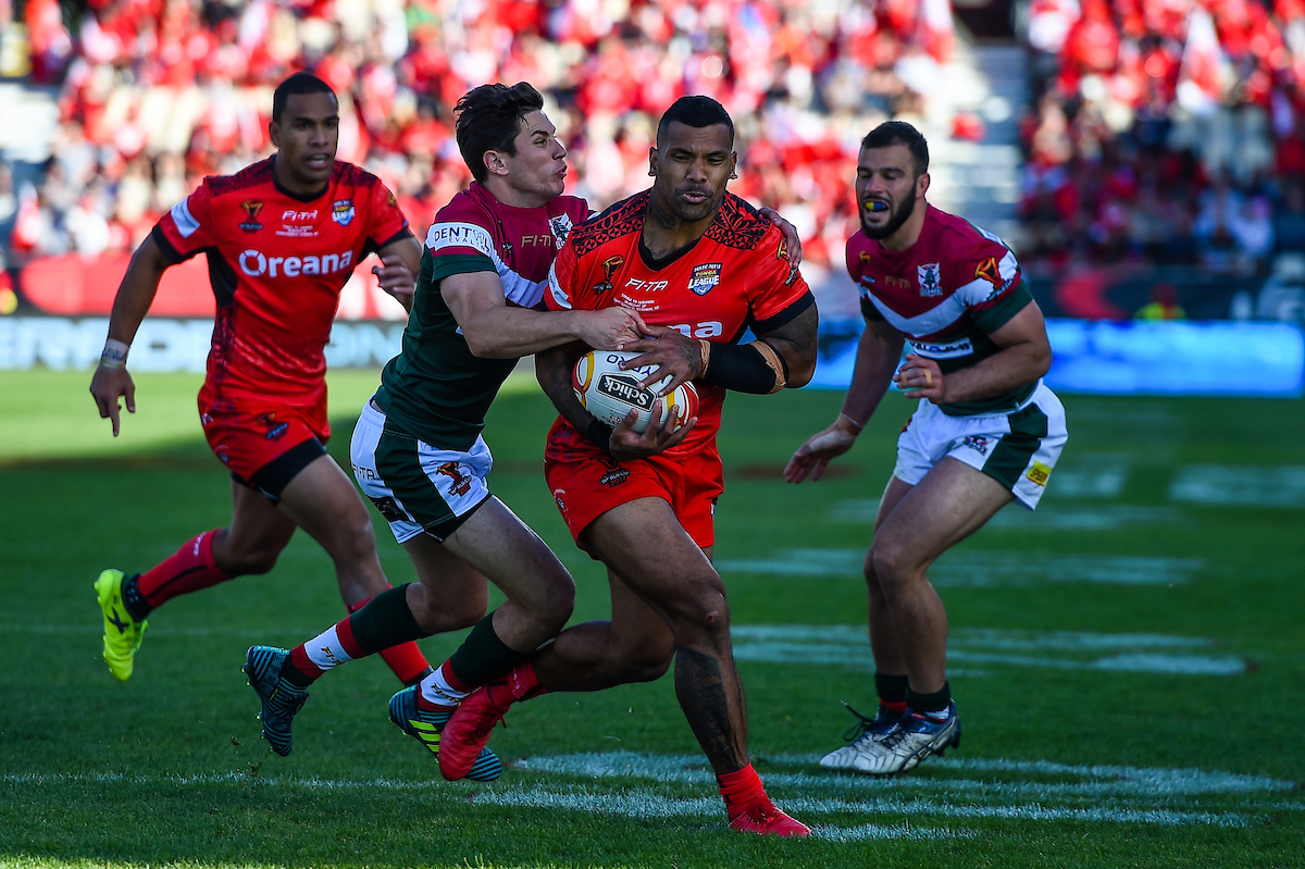 Cook Islands' Kayal Iro tackled by Tonga's Will Penisini during