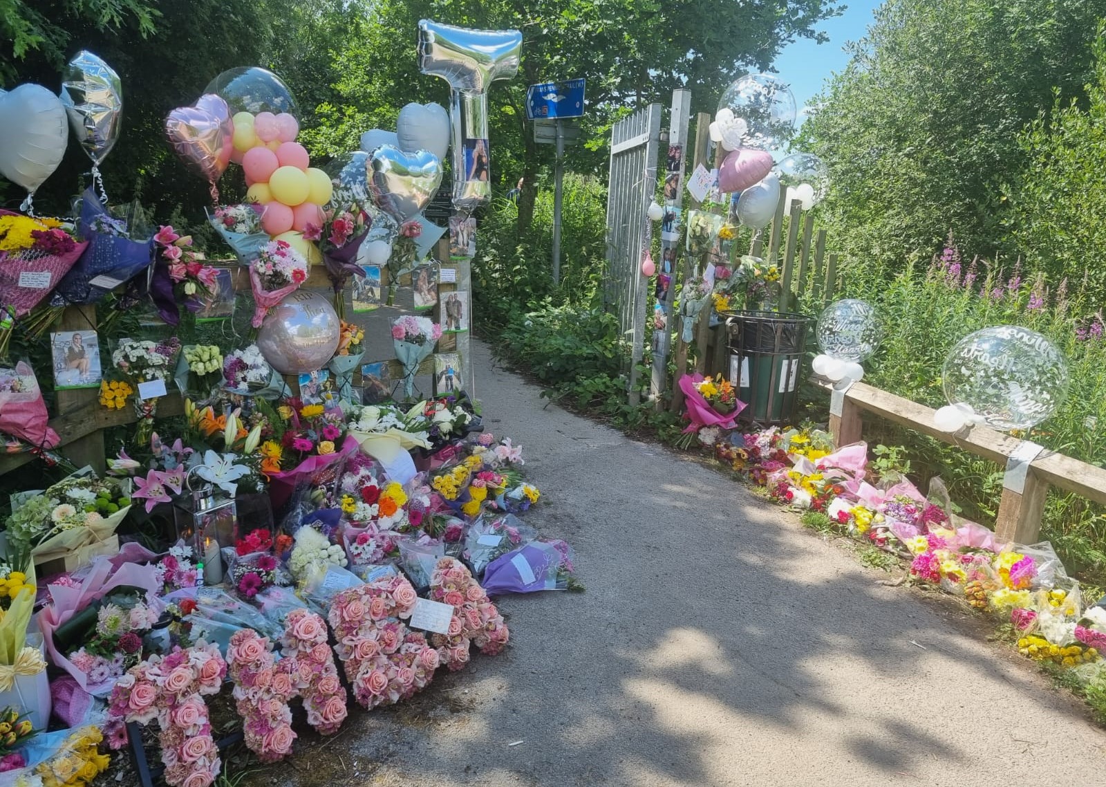 Floral tributes adorn the entrance to Saxon Park, near to where Theas car was discovered in Sankey Bridges.