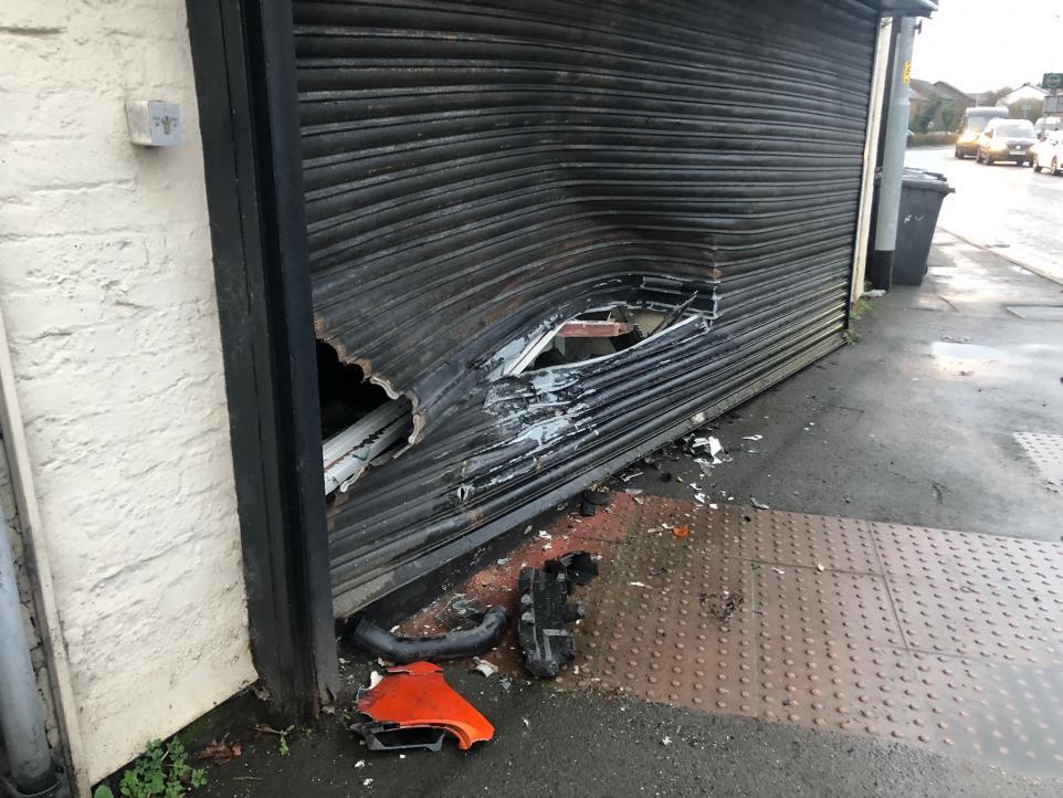 A previous crash caused damage to a business near to the lights