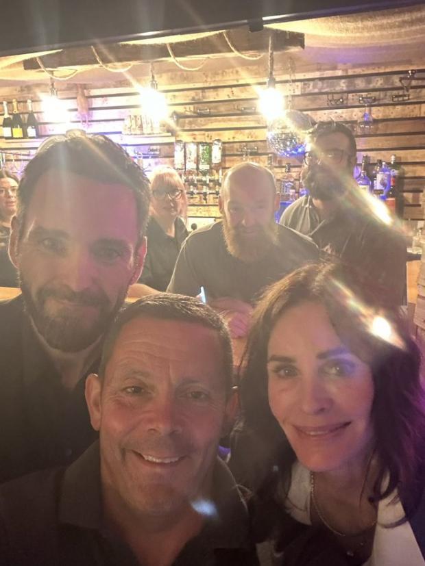 Friends star, Courteney Cox (right) with long-term partner, Johnny McDaid (left) with Delamere Events director, Ryan Cartwright (centre) and his staff (Image: Delamere Events)