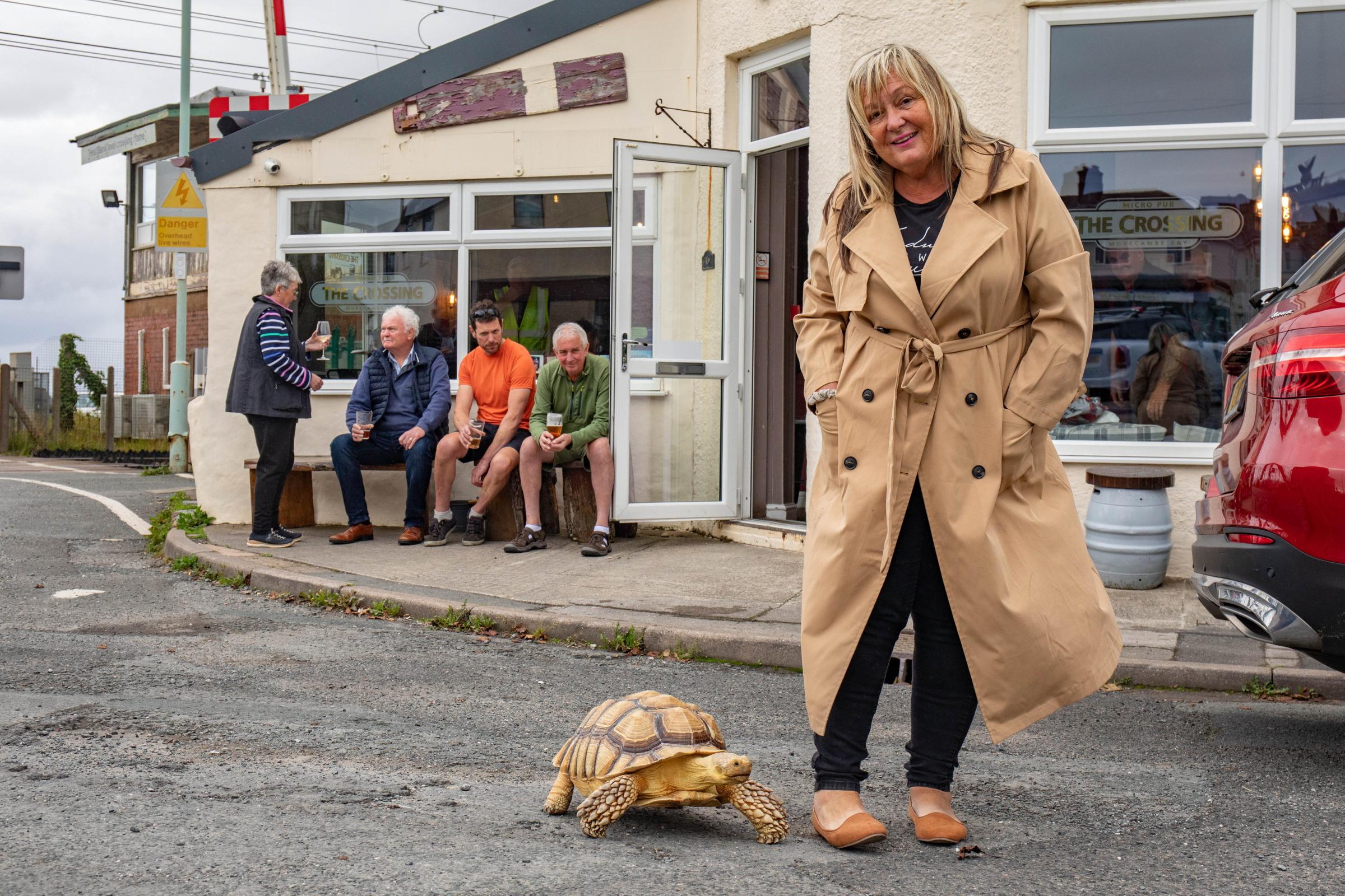 Jackie Leek takes her giant pet tortoise called Mr Miyagi on regular walks to the pub. Picture: SWNS